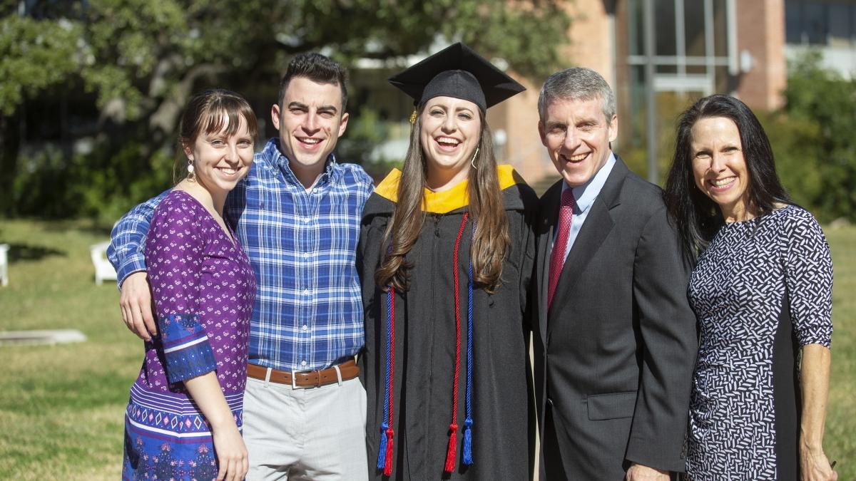 Trinity graduate and her family pose for quick photo after the ceremony